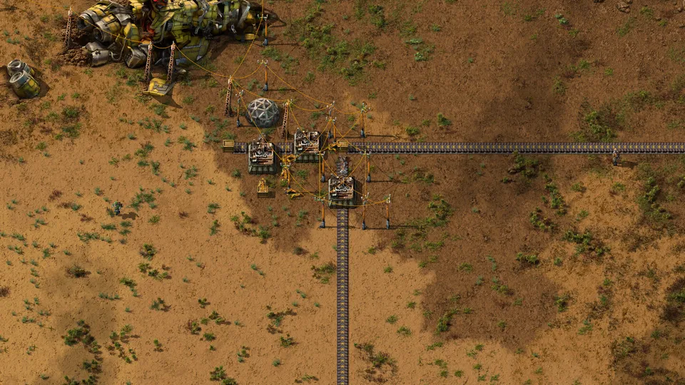Factorio: the final July base, a crash-site wreck, a lab, three assemblers on a belt line and power poles on sand